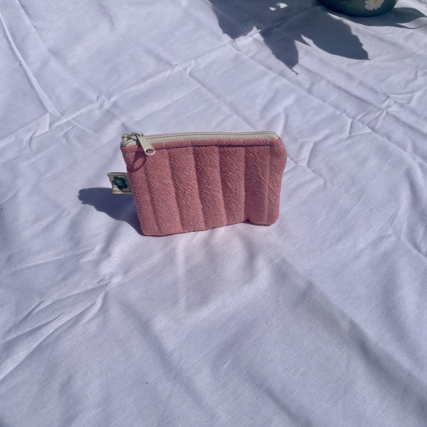 Flat zip pouch for small essentials, made from sustainable fabrics, in pink fabric.