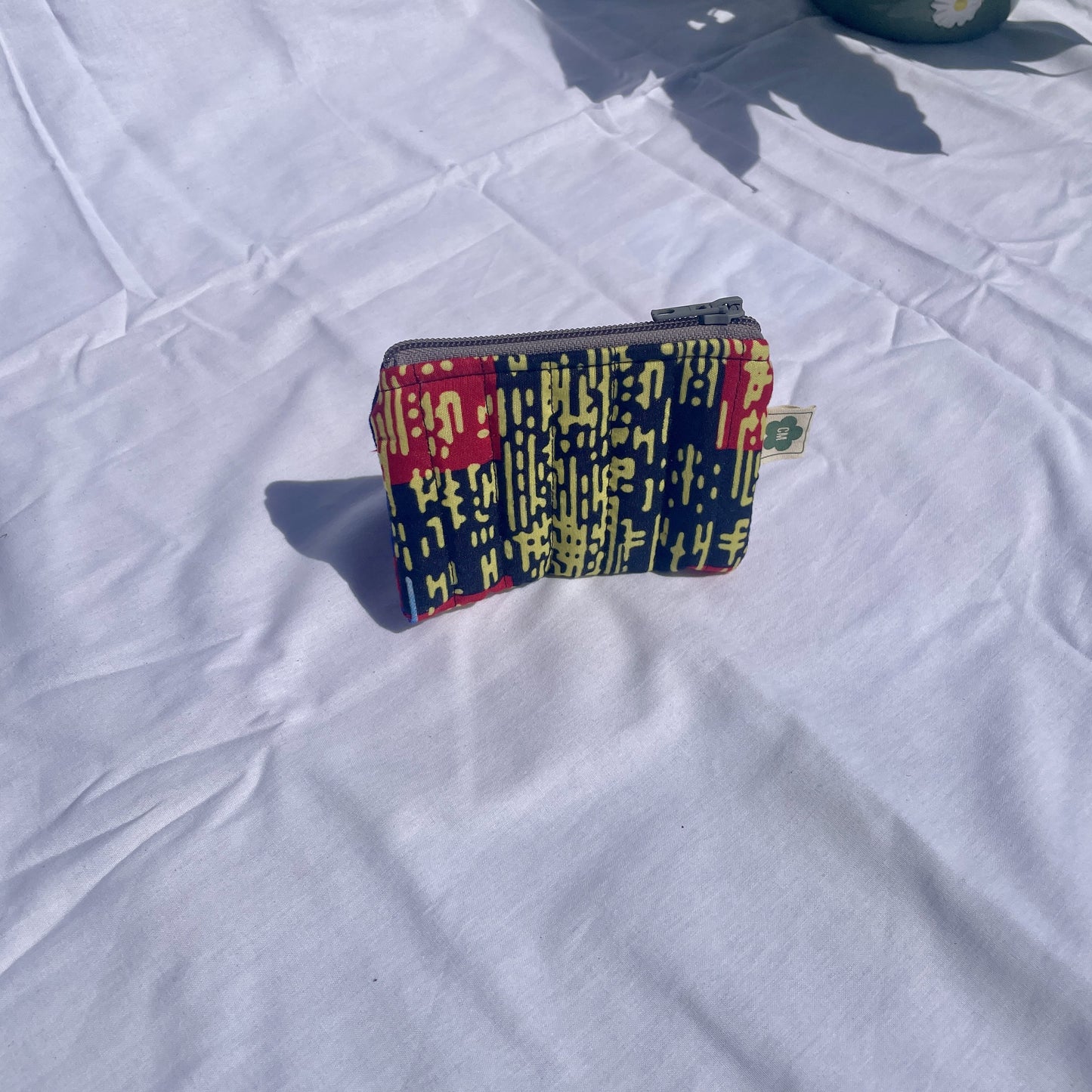 Flat handmade pouch made from upcycled and secondhand fabrics